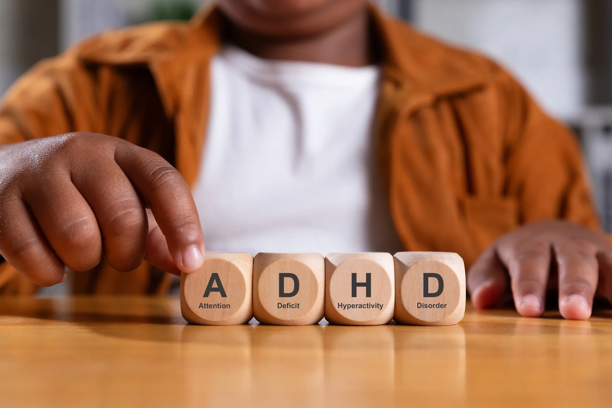 Child arranging ADHD wooden cubes