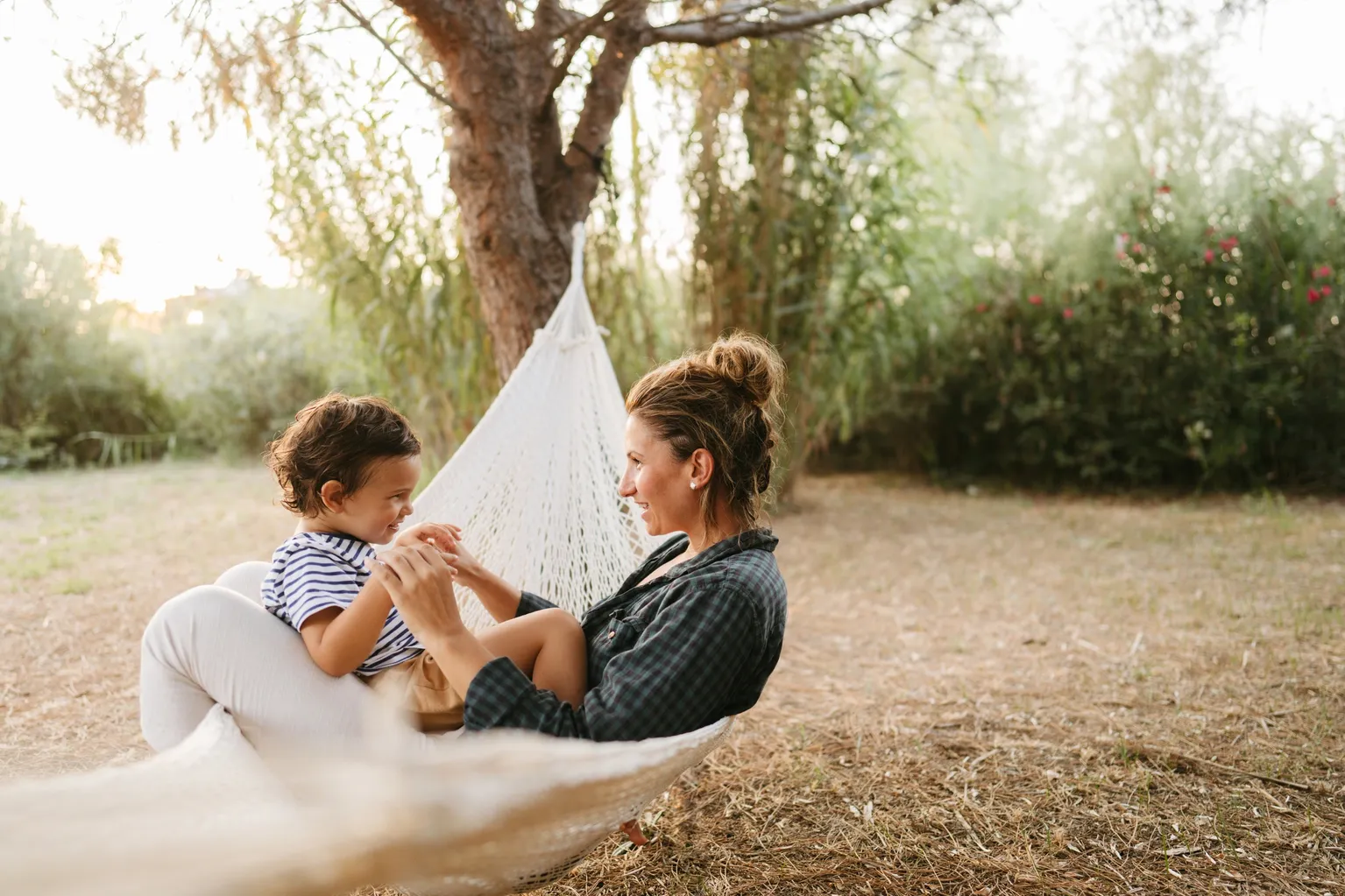 Mother and child in hammock outdoors