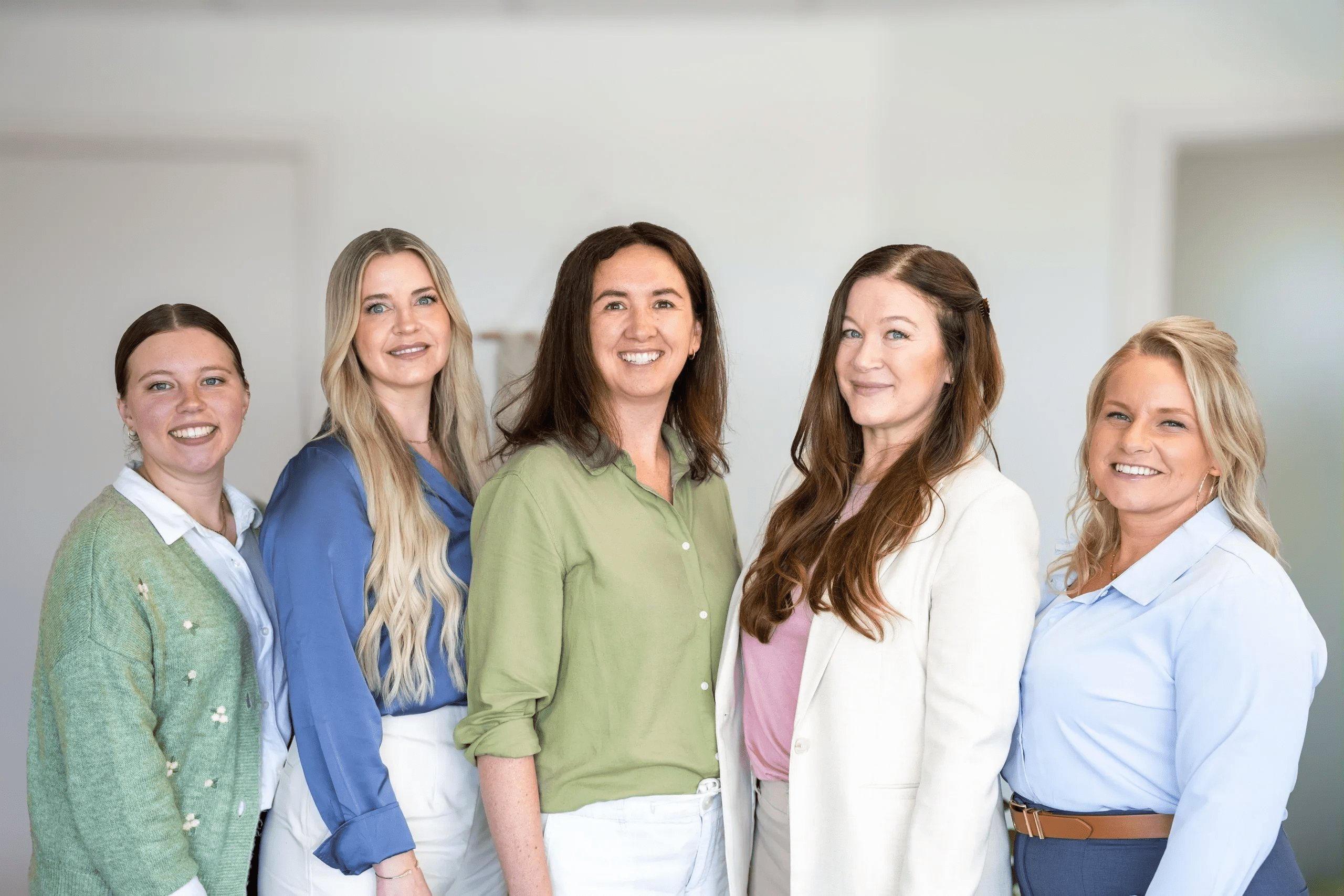 Smiling women standing indoors