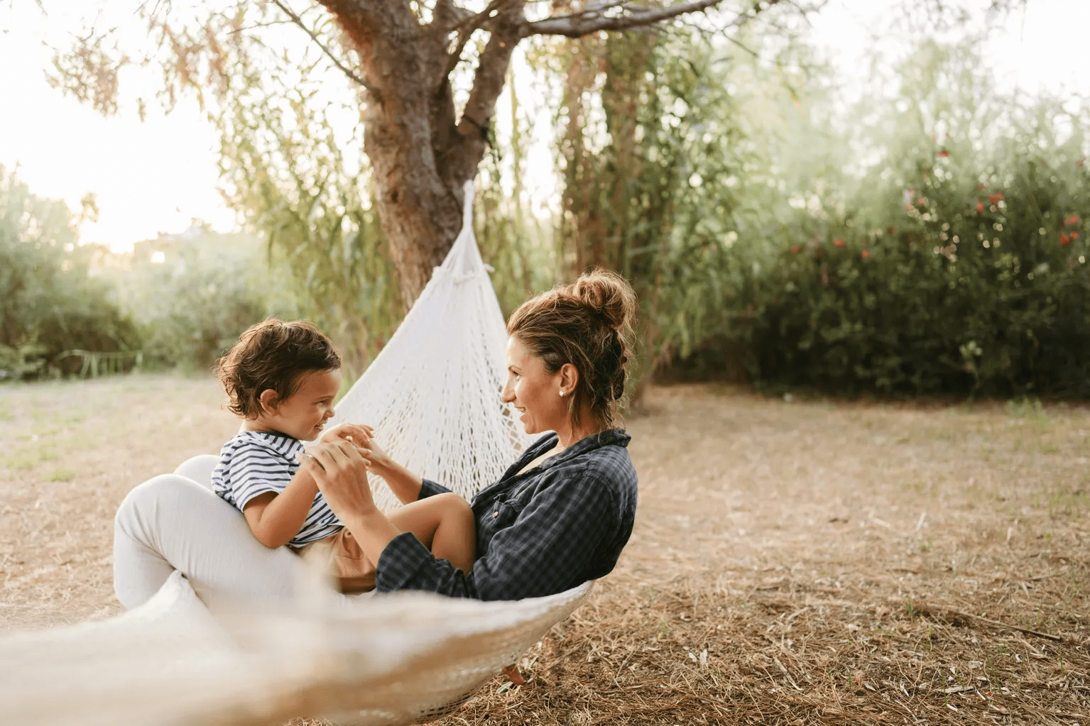 Mother and child in hammock outdoors