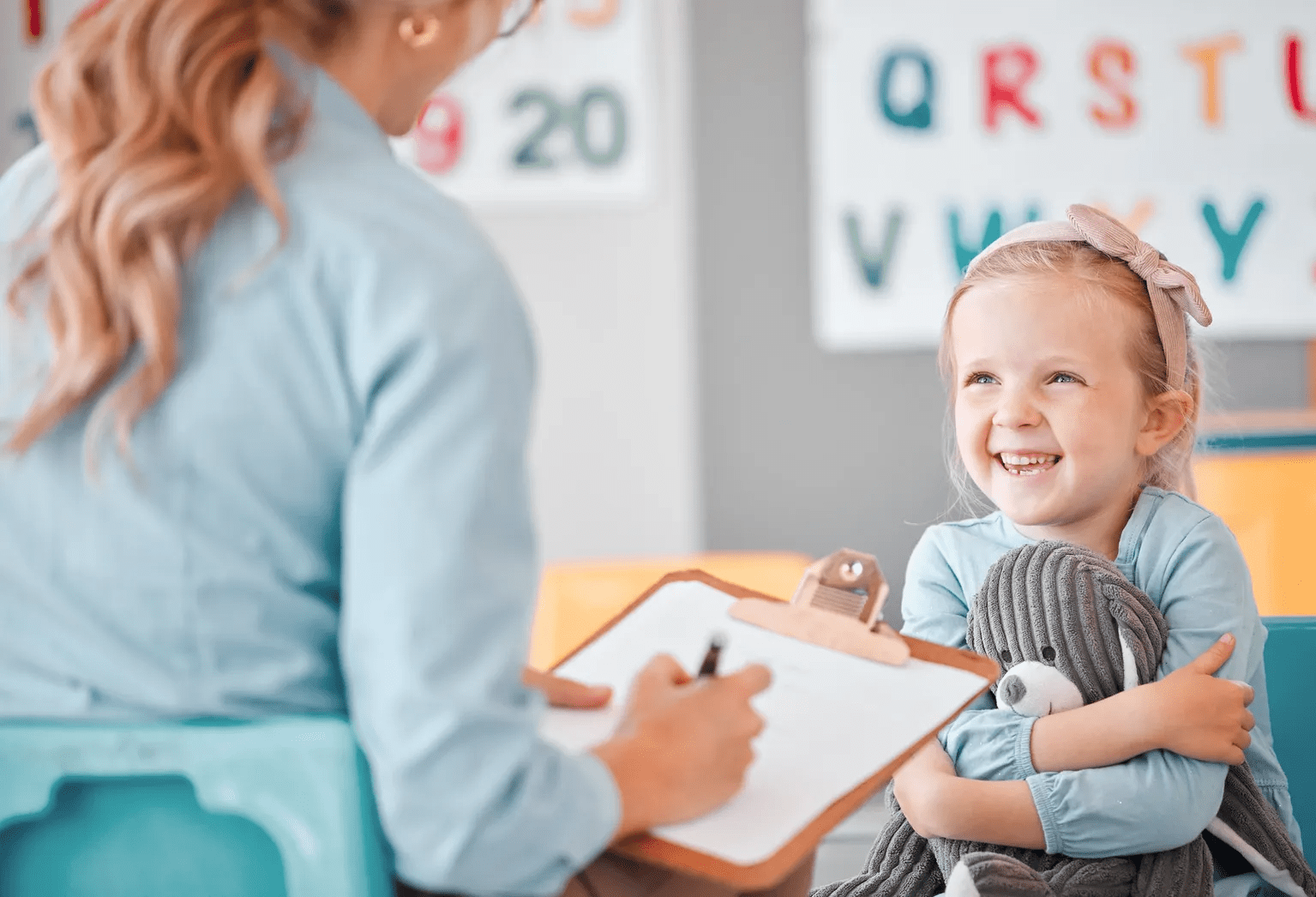 Happy child in learning environment with educator